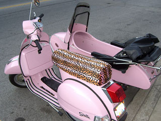 pink vespa with sidecar