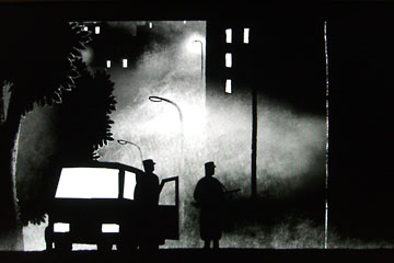 NIght scene of soldiers approaching a building