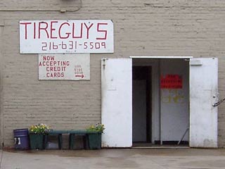Front of building with Tire Guys - we now accept credit cards sign