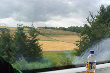 View from train toward fields of wheat