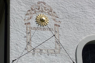 Sundial made with several cable and a scale painted on an exterior wall of the church