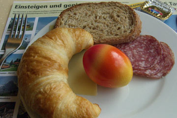 Croissant, bread, red and orange egg, cheese, salami