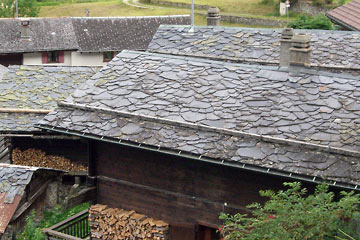 Cluster of houses, most with random slate roofs