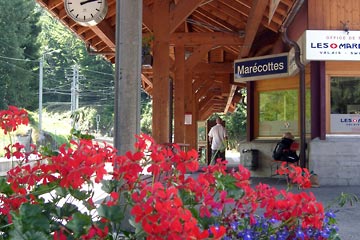 Les Marecottes train station with bright red geraniums in foreground