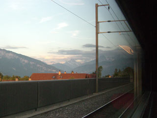 View of mountains at sunset through train window