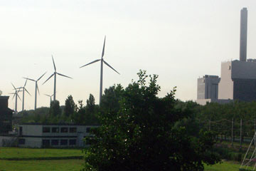 Row of wind turbines near power plant in Amsterdam
