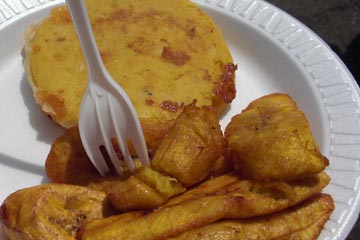 Plate with fried plantains and an arepa on it