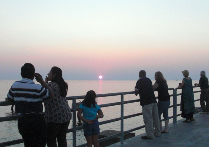 People watching sunset from pier