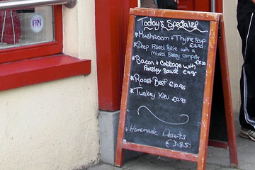 Menu board outside restaurant