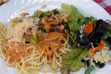 pasta topped with sauce and daylilies