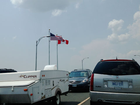 American and Canadian flags on bridge