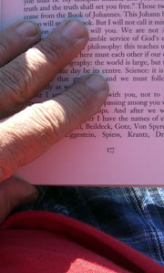 Me holding a book, with bluish shadows cast by my fingers