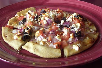Mediterranean Pita Pitza, with feta cheese, olives and onions.