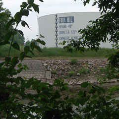 Looking across the river to the oil storage tank