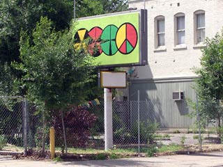 Peace sign and others marking urban garden on Lorain Avenue