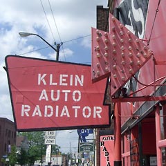 Klein Radiator sign with lights and arrow