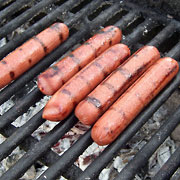 Five hot dogs on grill