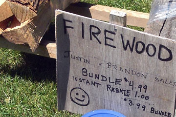 Hand-lettered sign offering instant rebate on firewood