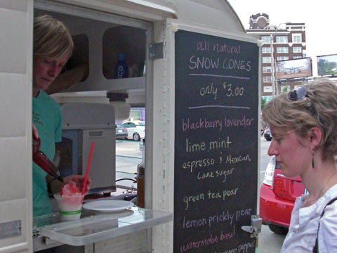 Woman buying snowcone at vending cart