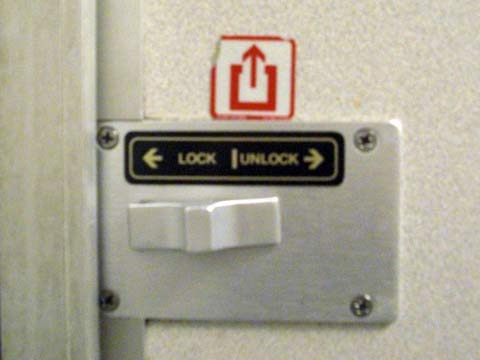 Amtrak restroom door lock with exit symbol