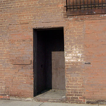 Dark doorway in brick wall