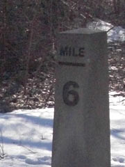 Stone milepost marked 6