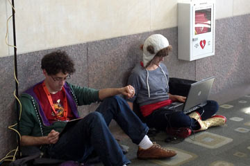 People sitting on floor with laptops