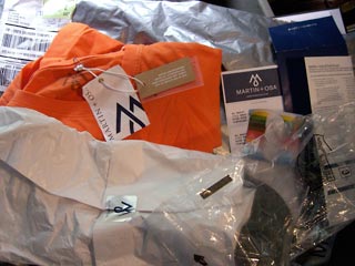 Orange T-shirt surrounded by various pieces of packing material