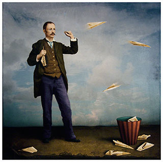 Man with mustache throwing a paper airplane while holding another.