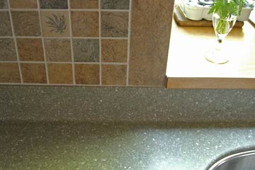 Detail of kitchen counter, backsplash and window