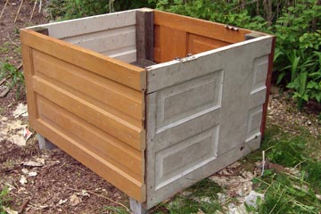 Raised bed with sides made from pieces of door