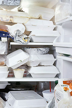 Lots of take-out containers inside a refrigerator