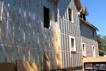 South side of house with window openings framed in