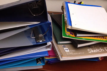 stack of binders on desk