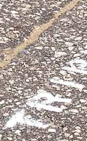 Close-up of white letters on asphalt
