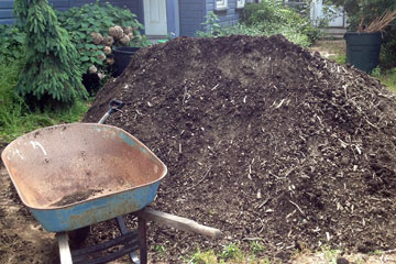 Wheelbarrow next to a big pile of dirt