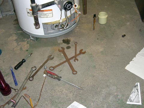 Tools spread out on floor near water heater