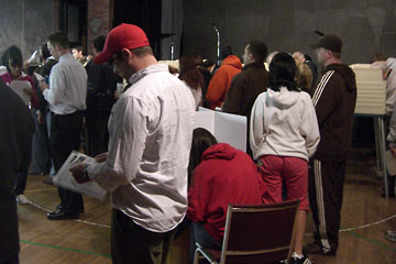 People standing in lines at polling place