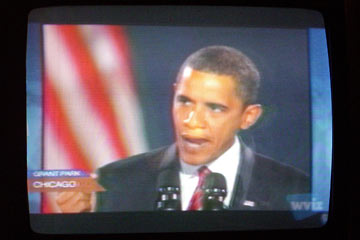Barack Obama speaking, on TV screen