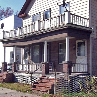 Front porch of duplex house with brick steps