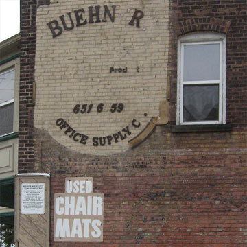 Boarded up storefronts with Open sign