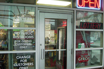 Restaurant door with signs about various things