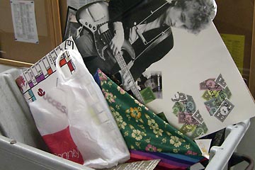 Load of trash in bin includes large Bob Dylan poster