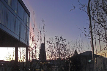 Pink clouds at sunset reflected in glass building walls