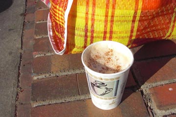Cappuchino and shopping bag in the sun