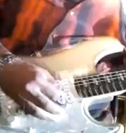 Close-up of Ronnie Baker Brooks playing guitar