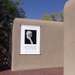 Exterior stucco wall of O'Keefe Museum with photograph of her 