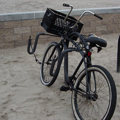 Fat-tired beach cruiser bike with surfboard rack on side
