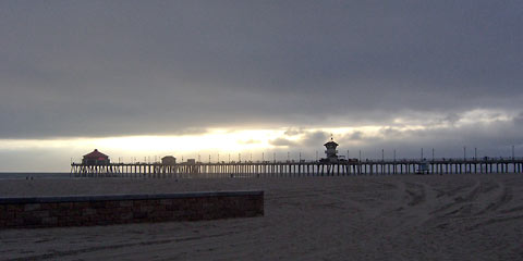 Huntington Beach pier with bright sun at horizon