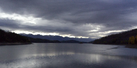 Dark clouds over still lake
